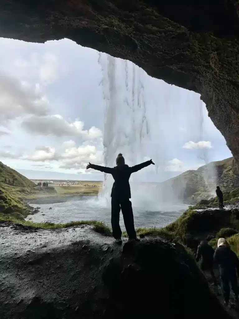 Walk behind a waterfall during your Iceland roadtrip itinerary with a car. 