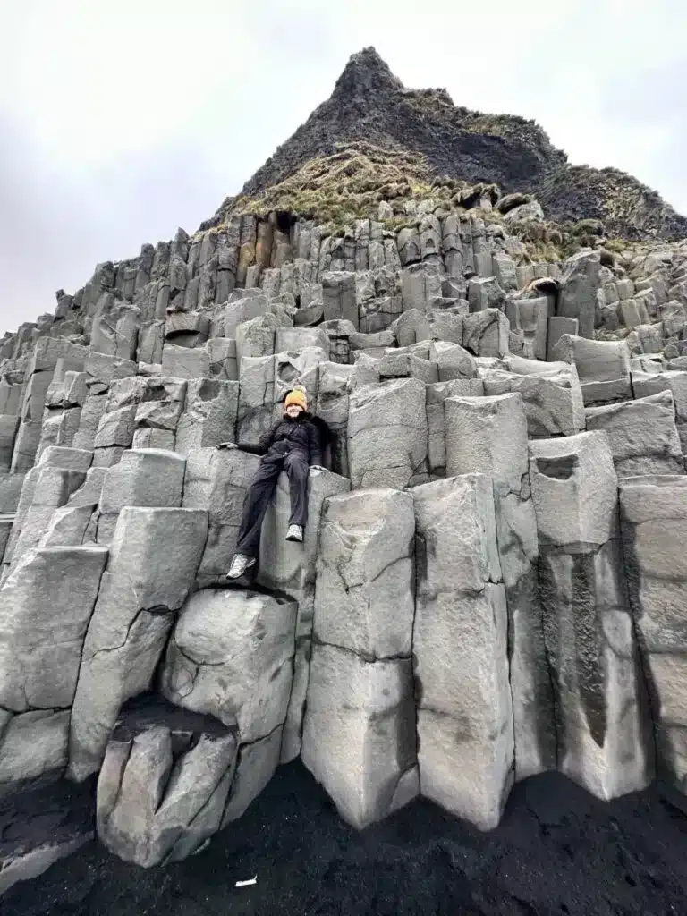 Sitting on basalt columns on the Black Sand Beach along Iceand's South Coast, one of the popular sights between Selfoss and Vik. 