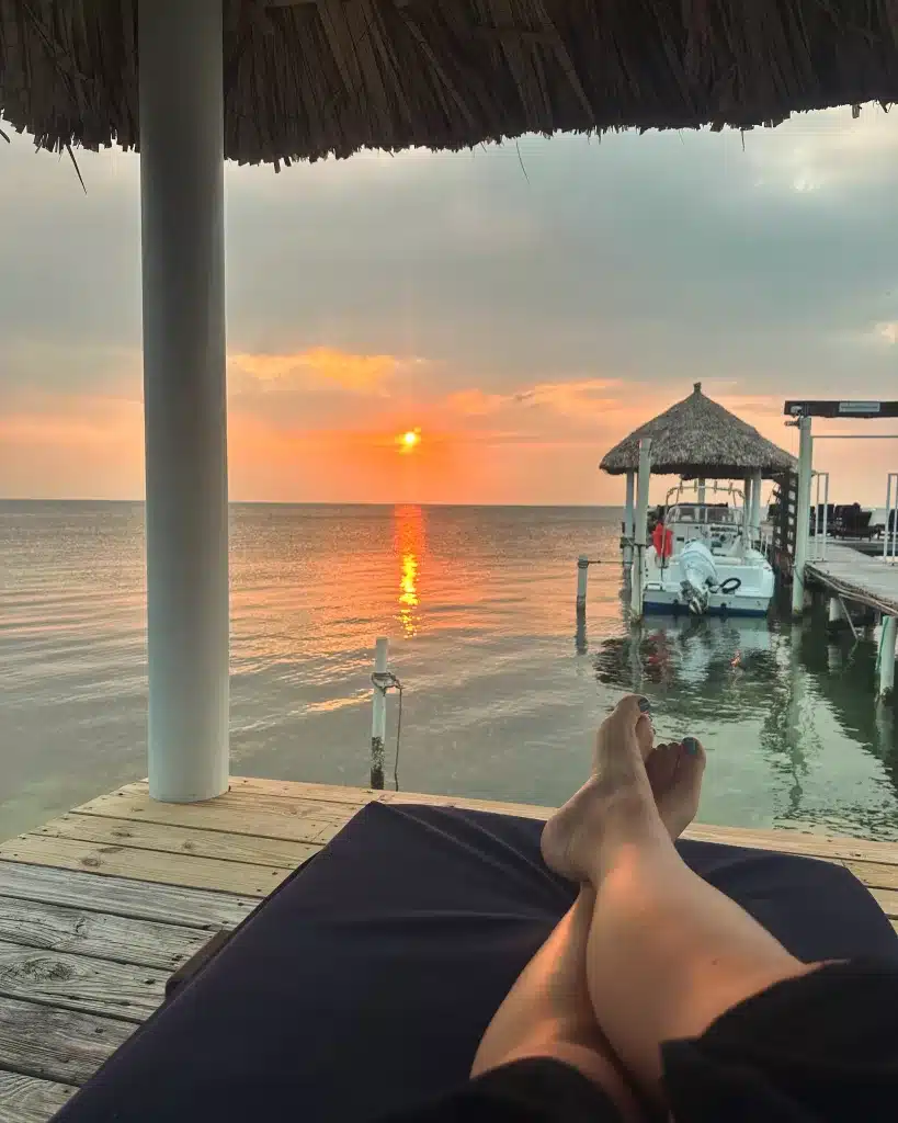 Enjoying the sunrise on the dock at our oceanfront home rental on Caye Caulker.