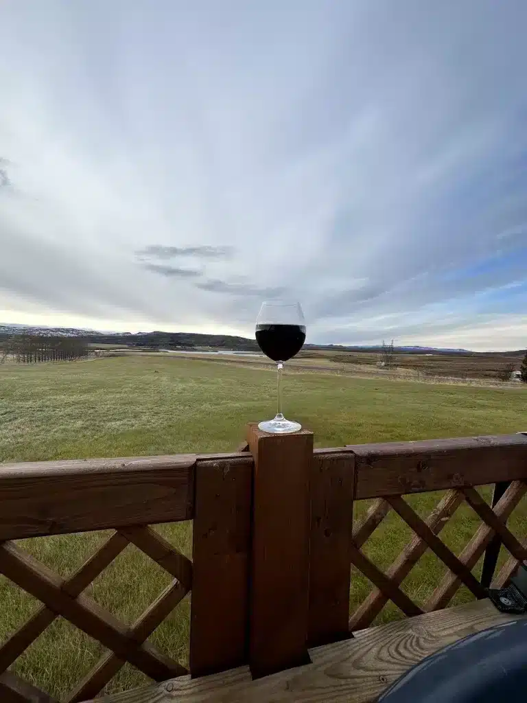 Enjoying a glass of wine while soaking in hot springs water in Iceland.