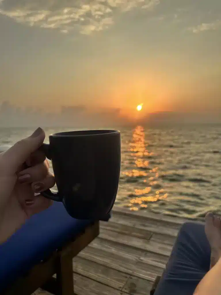 Sipping coffee and watching son and husband fish off the dock in Belize using saltwater fishing lures. 